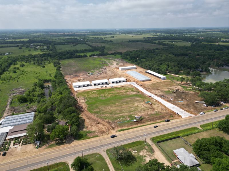 Aerial view of a graded commercial site along a highway, near Paris, TX